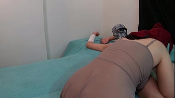 Arab Muslim woman in hijab riding a cock
